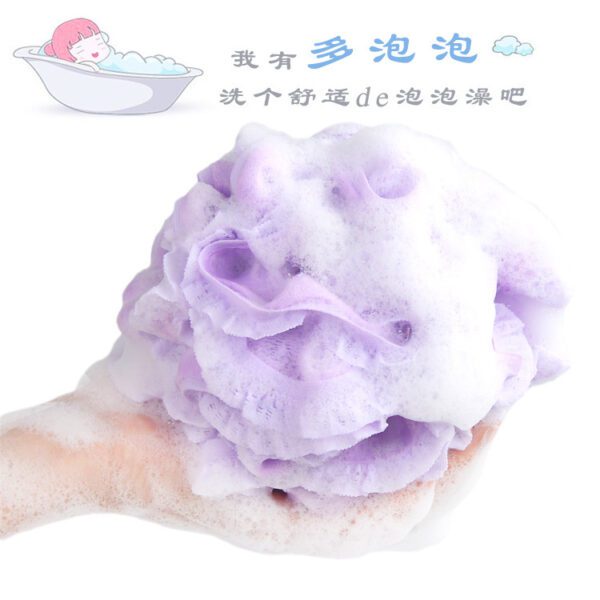 A person is holding a purple Mesh Bath Ball Shower Sponge in their hand.