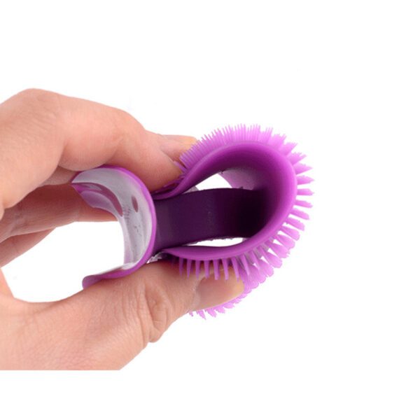 A person holding a purple Silicone Cleaning Face Scrubber Brush with a purple handle.